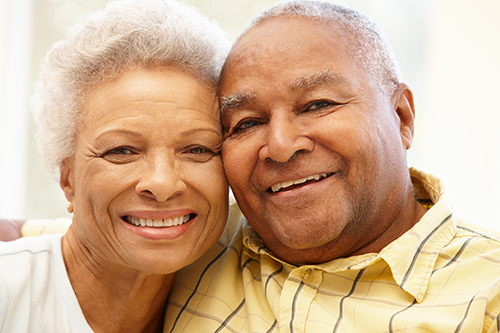 African american couple smiling sitting closely